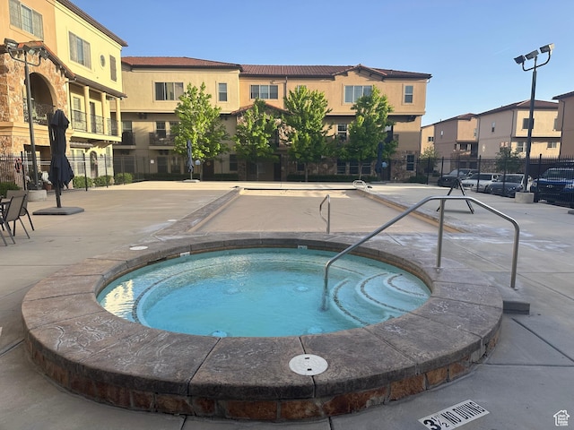 5516 W Florence Ln N, Highland, UT 84003 - view of swimming pool featuring a community hot tub, a pool, and a residential view