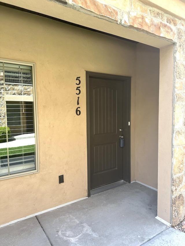 5516 W Florence Ln N, Highland, UT 84003 - doorway to property with stone siding and stucco siding