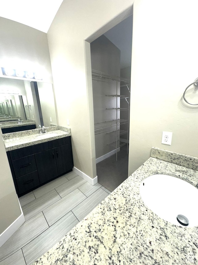 5516 W Florence Ln N, Highland, UT 84003 - bathroom featuring vanity, a walk in closet, and wood tiled floors
