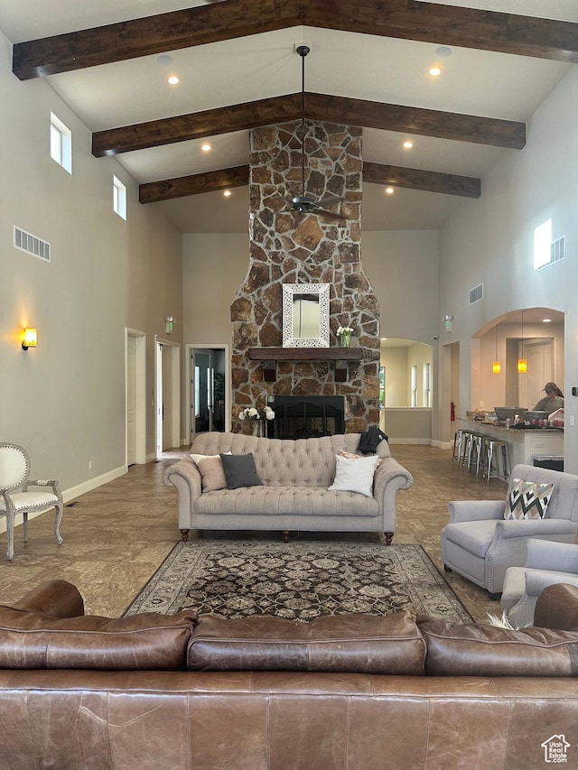 5516 W Florence Ln N, Highland, UT 84003 - living area featuring a high ceiling, arched walkways, beam ceiling, a fireplace, and recessed lighting