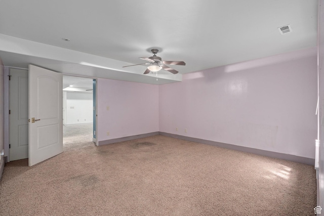 unfurnished room with a ceiling fan, light colored carpet, and baseboards