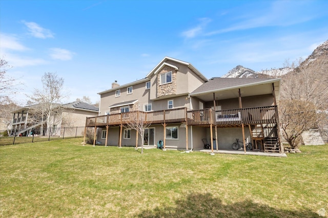 rear view of property featuring a deck, stucco siding, stairs, and a chimney