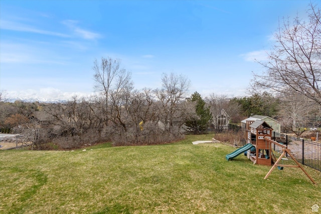 view of yard featuring a playground and view of scattered trees