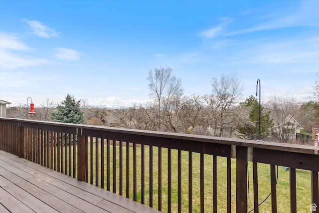 wooden deck with a lawn