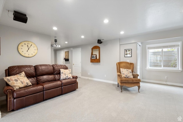 living area featuring recessed lighting, baseboards, and light colored carpet