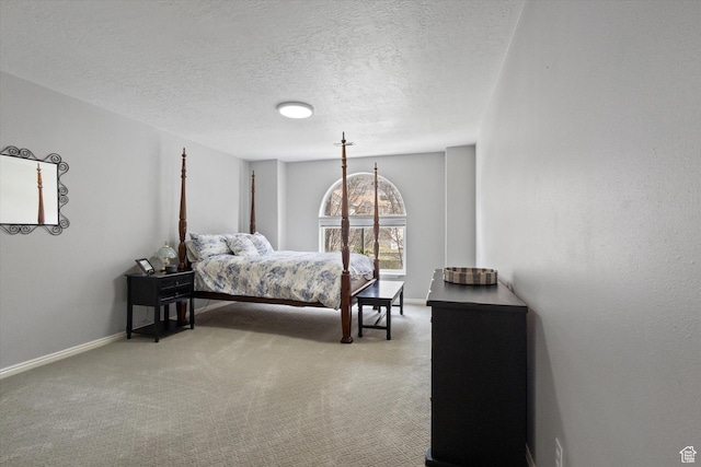 carpeted bedroom featuring baseboards and a textured ceiling