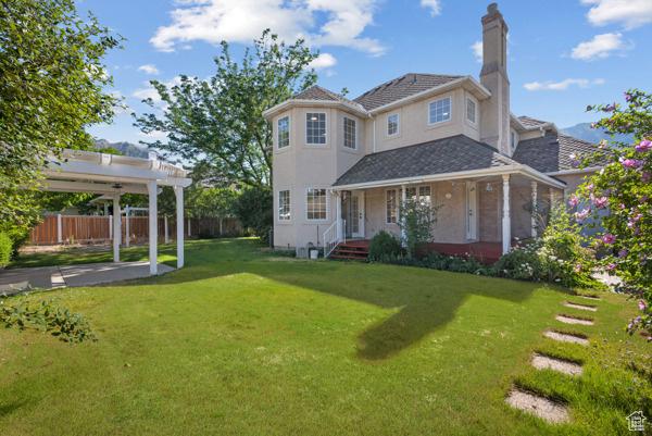 441 N Palisades Dr, Orem, UT 84097 - back of house with a pergola, a chimney, and stucco siding