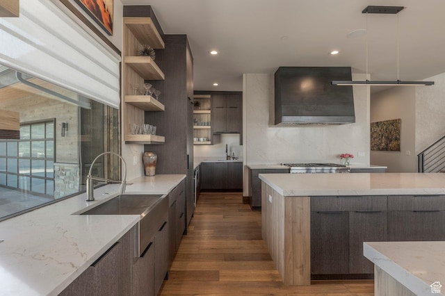 kitchen featuring open shelves, modern cabinets, exhaust hood, wood finished floors, and recessed lighting