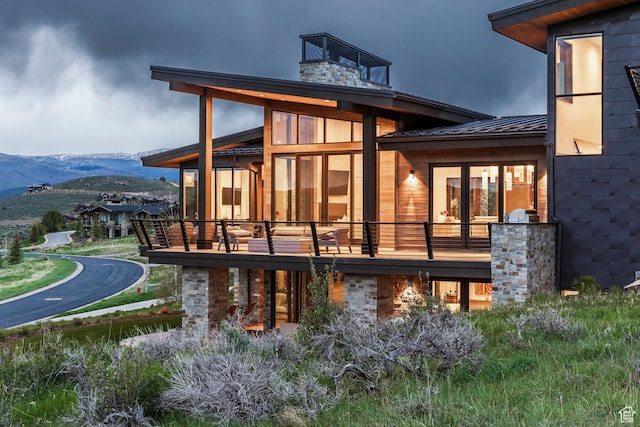 6110 E Blue Wing Loop, Kamas, UT 84036 - rear view of property featuring a mountain view, a balcony, a chimney, metal roof, and a standing seam roof