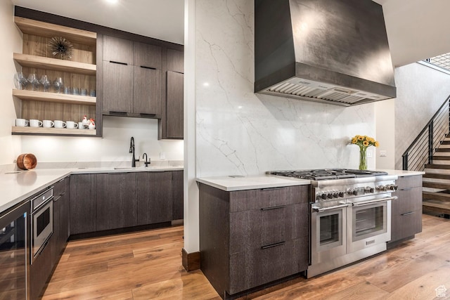 6110 E Blue Wing Loop, Kamas, UT 84036 - kitchen with wall chimney range hood, range with two ovens, modern cabinets, and dark brown cabinetry
