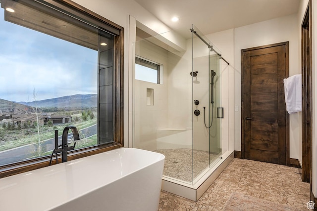 6110 E Blue Wing Loop, Kamas, UT 84036 - full bath with a shower stall, a freestanding bath, a mountain view, and recessed lighting
