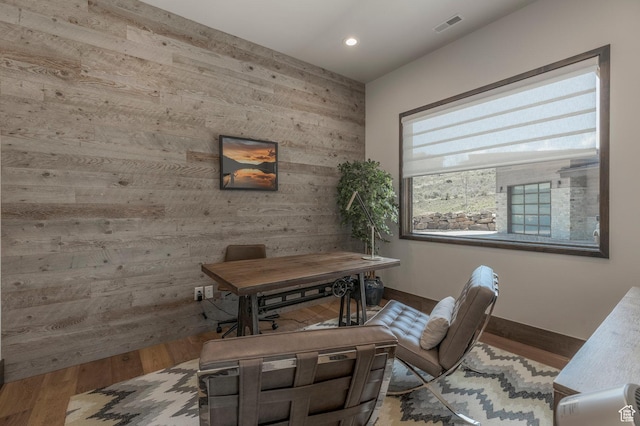 home office featuring wooden walls, wood finished floors, recessed lighting, and baseboards