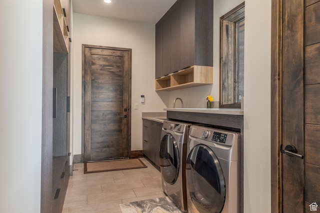 clothes washing area featuring separate washer and dryer, cabinet space, recessed lighting, baseboards, and light tile patterned floors
