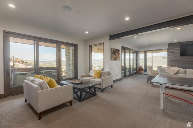 carpeted living room featuring recessed lighting and baseboards
