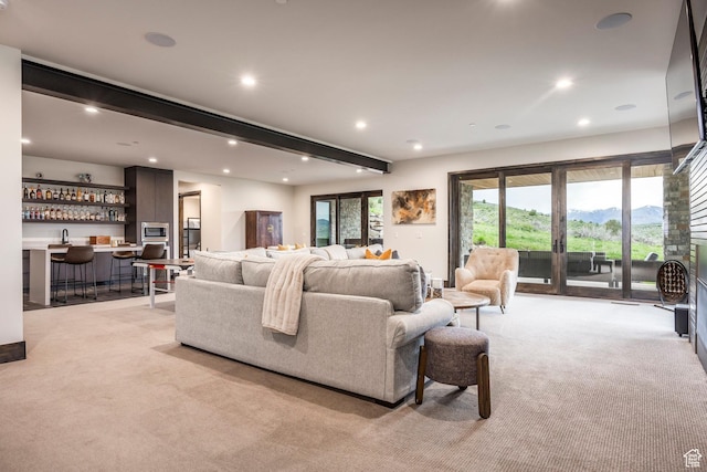 6110 E Blue Wing Loop, Kamas, UT 84036 - living room with light colored carpet, beam ceiling, bar with sink, and recessed lighting