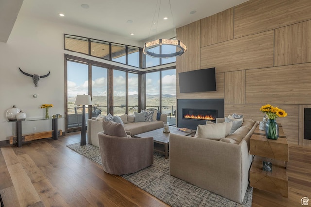 living room featuring a fireplace, wood finished floors, and recessed lighting