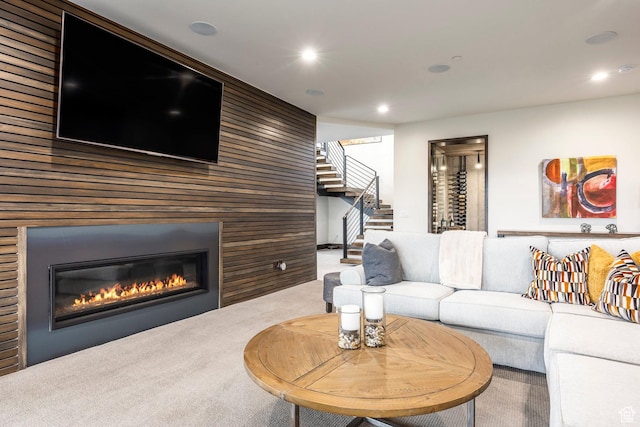 6110 E Blue Wing Loop, Kamas, UT 84036 - carpeted living room featuring stairway, wood walls, a glass covered fireplace, and recessed lighting