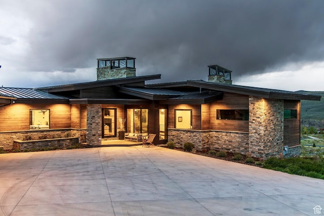 6110 E Blue Wing Loop, Kamas, UT 84036 - contemporary home featuring stone siding, a standing seam roof, metal roof, and a porch