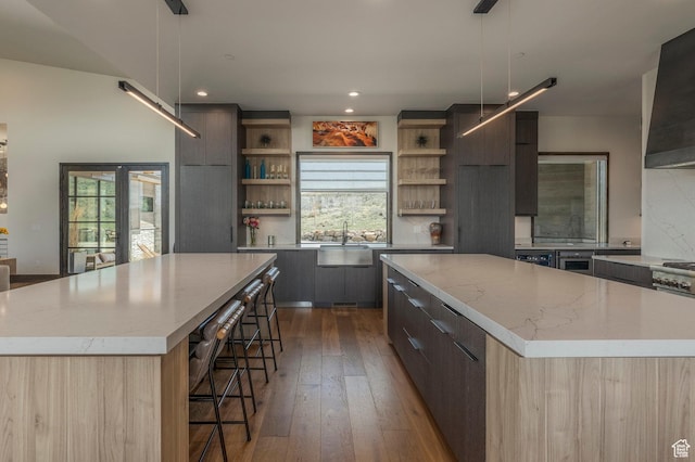 kitchen featuring modern cabinets, a spacious island, open shelves, backsplash, and recessed lighting