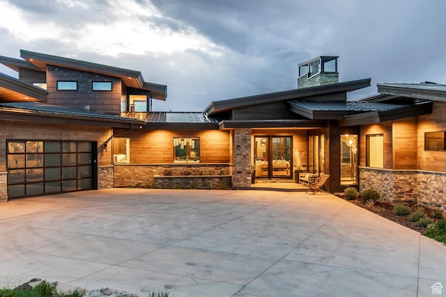 6110 E Blue Wing Loop, Kamas, UT 84036 - view of front of house with a standing seam roof, metal roof, driveway, and stone siding