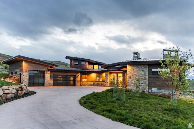 6110 E Blue Wing Loop, Kamas, UT 84036 - modern home with a standing seam roof, an attached garage, stone siding, and driveway