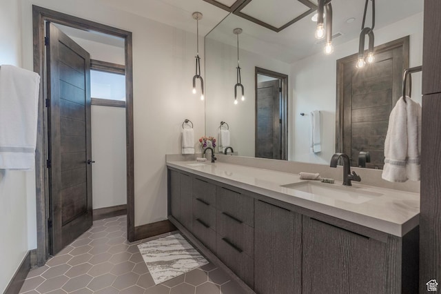 bathroom featuring double vanity, baseboards, and tile patterned floors