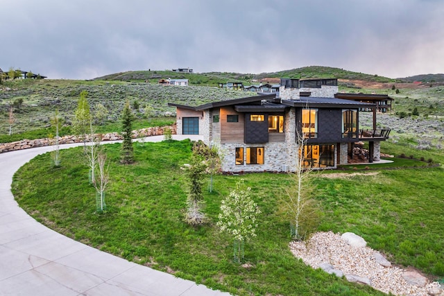 6110 E Blue Wing Loop, Kamas, UT 84036 - view of property exterior featuring an attached garage, stone siding, concrete driveway, and a yard