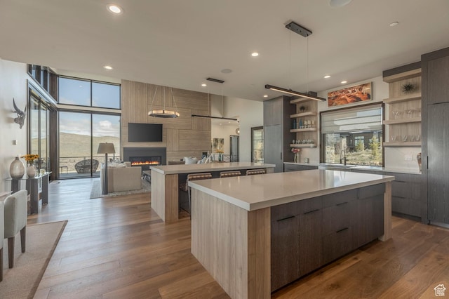 kitchen featuring modern cabinets, open shelves, a spacious island, plenty of natural light, and recessed lighting