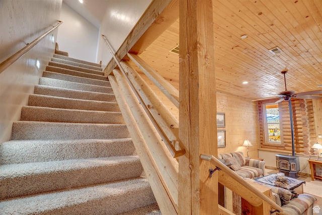 9174 Deer Creek Dr, Heber City, UT 84032 - stairway featuring a wood stove, wooden ceiling, a ceiling fan, and recessed lighting