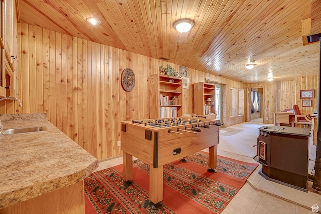 9174 Deer Creek Dr, Heber City, UT 84032 - rec room with a sink, wooden walls, wood ceiling, a wood stove, and tile patterned flooring