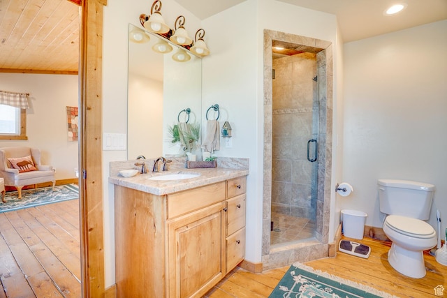 9174 Deer Creek Dr, Heber City, UT 84032 - bathroom featuring hardwood / wood-style floors, a shower stall, toilet, vanity, and recessed lighting