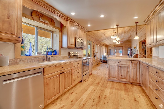 9174 Deer Creek Dr, Heber City, UT 84032 - kitchen featuring appliances with stainless steel finishes, a sink, light wood-style floors, a peninsula, and light brown cabinets