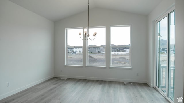 5488 N Trailside Unit 431, Eagle Mountain, UT 84005 - unfurnished dining area with light wood finished floors, a chandelier, vaulted ceiling, and baseboards