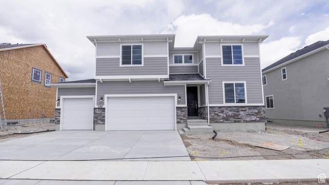 5488 N Trailside Unit 431, Eagle Mountain, UT 84005 - view of front of property featuring stone siding, driveway, and an attached garage