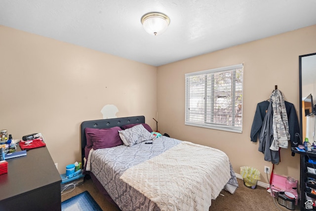 bedroom featuring carpet flooring and baseboards