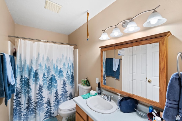 bathroom with toilet, vanity, and a shower with curtain