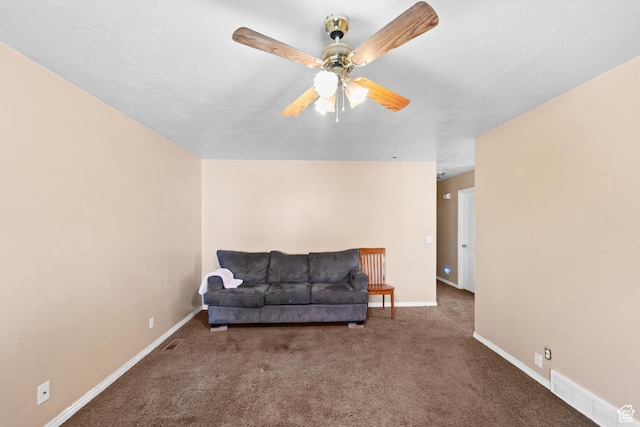 living area with carpet, a ceiling fan, and baseboards