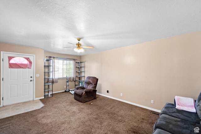 living area with carpet, baseboards, and ceiling fan