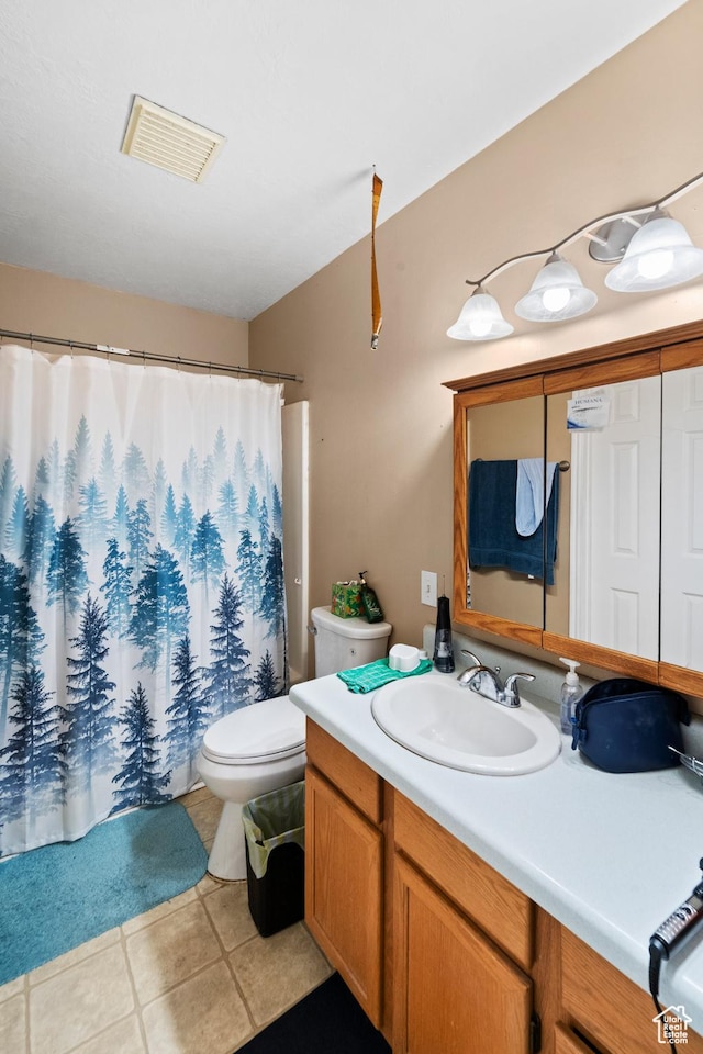 full bath with tile patterned floors, vanity, toilet, and curtained shower