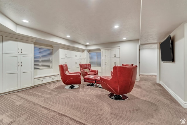 sitting room featuring light carpet, baseboards, and recessed lighting