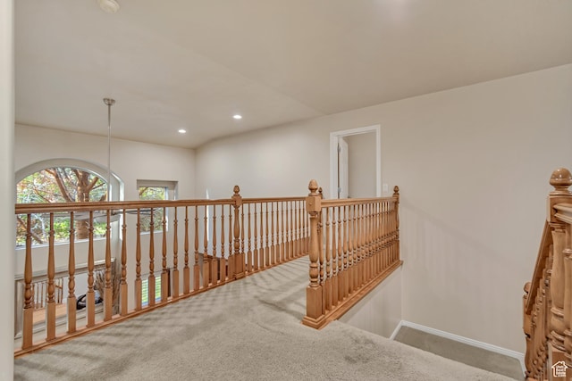 corridor with an upstairs landing, carpet floors, baseboards, and recessed lighting