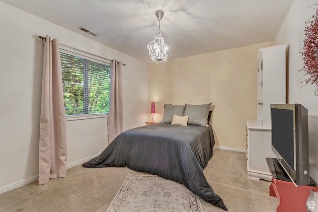 bedroom featuring light colored carpet, a chandelier, and baseboards