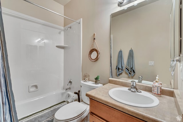bathroom featuring toilet, shower / washtub combination, and vanity