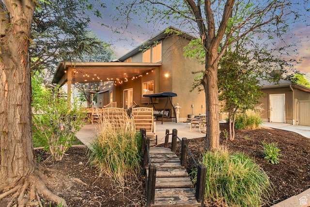 view of front of home featuring a patio and stucco siding