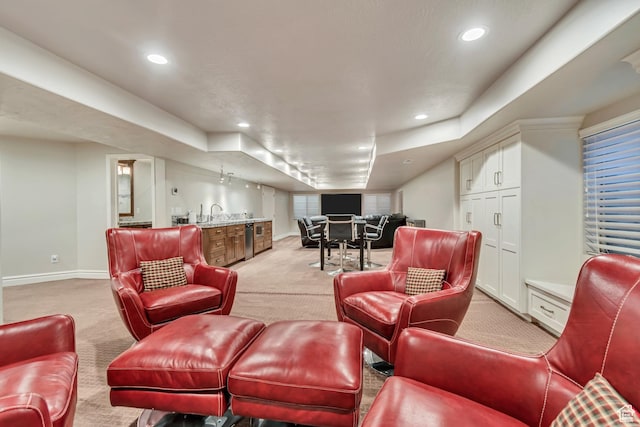 living room with light carpet, wet bar, baseboards, and recessed lighting