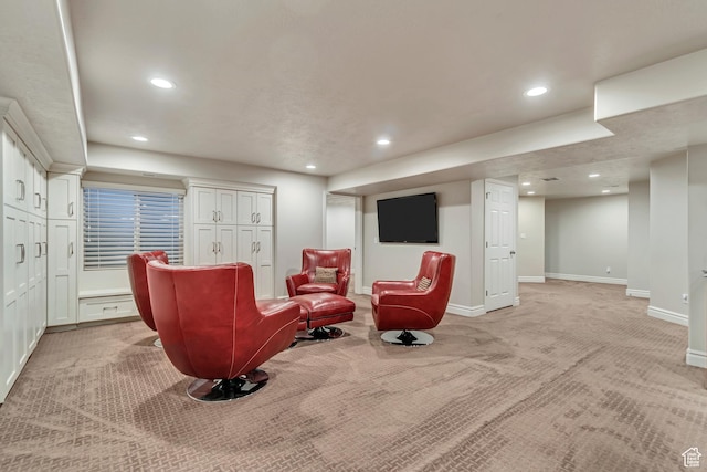 sitting room featuring light carpet, recessed lighting, and baseboards