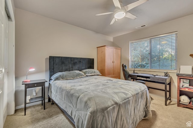 bedroom with light carpet, baseboards, and ceiling fan