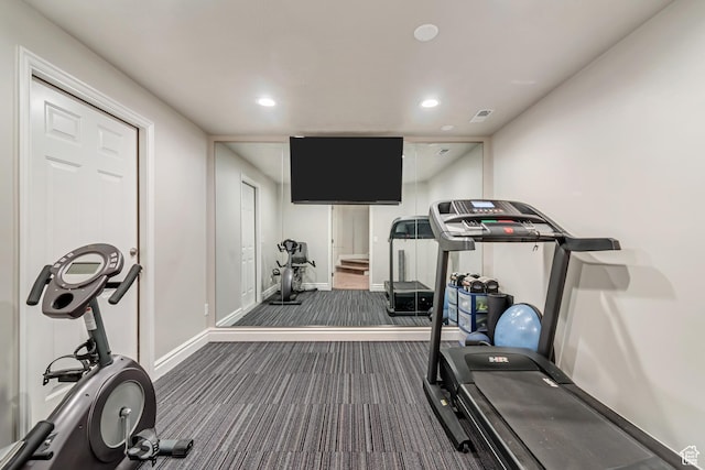 exercise room featuring dark colored carpet, baseboards, and recessed lighting