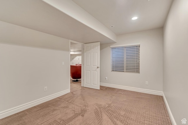 finished below grade area with carpet floors, baseboards, and recessed lighting