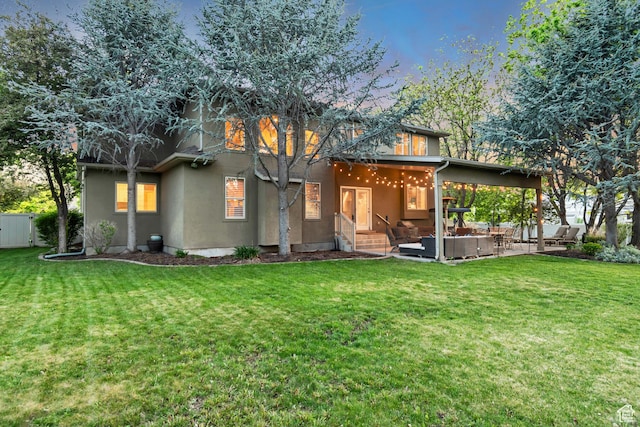 rear view of property featuring outdoor lounge area and a patio